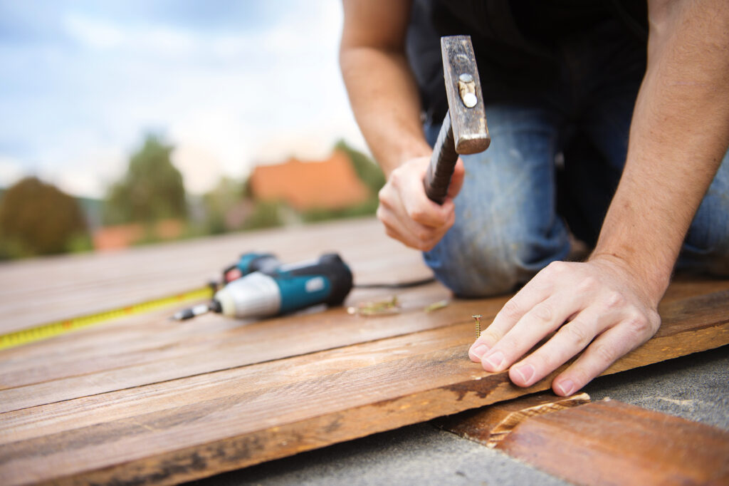 Hammering nail into wood